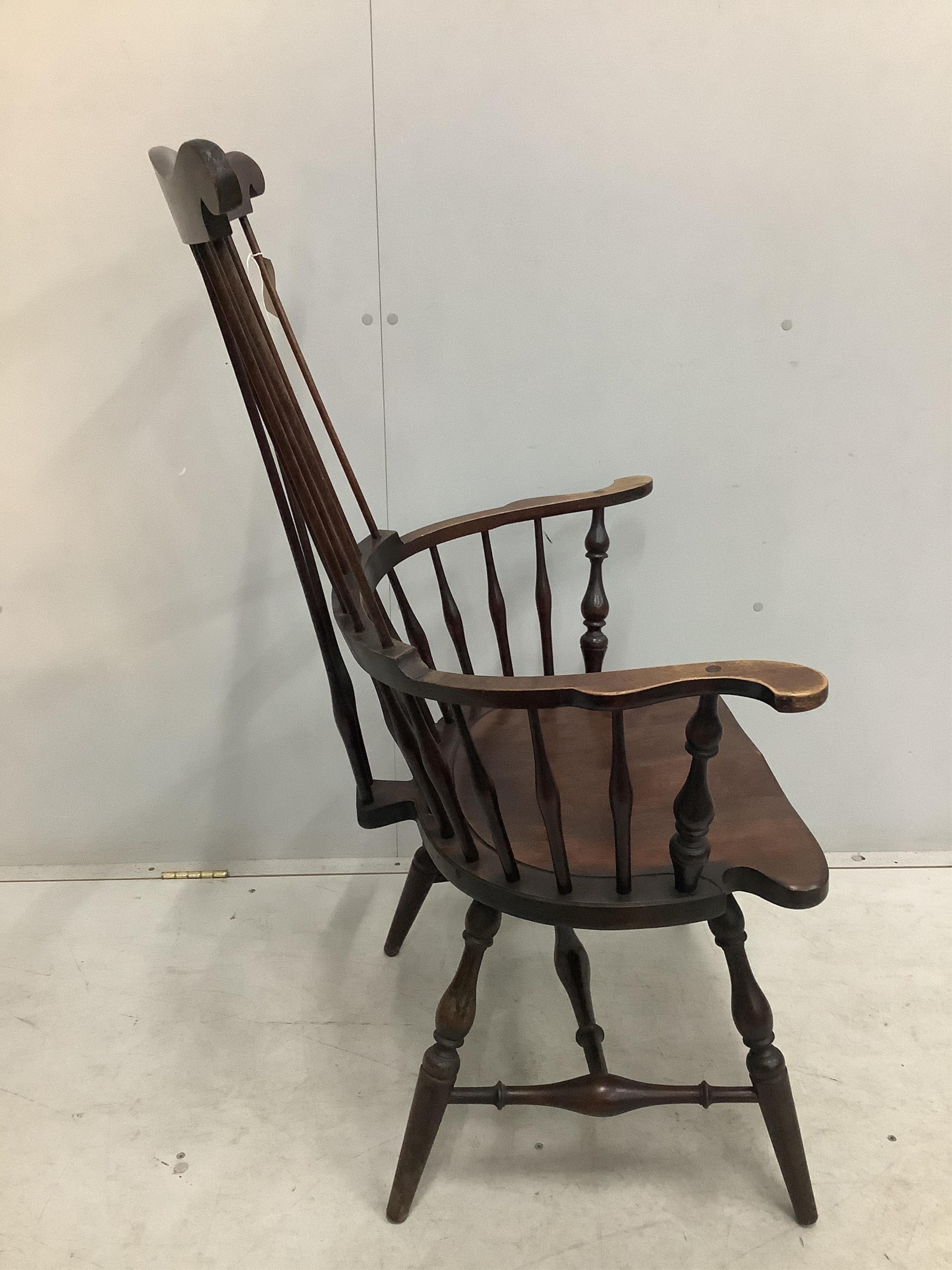 A 20th century American Windsor beech comb back armchair, width 73cm, depth 51cm, height 113cm. Condition - fair